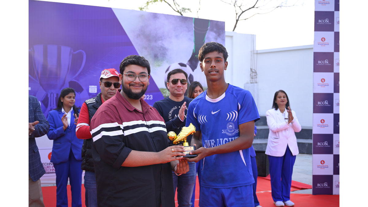 Mr. Debdut Roy Chowdhury, Director, Techno India Group handing over the Best Player and Top Scorer Trophy to a player from Lime Light Senior Secondary School, Bagdogra